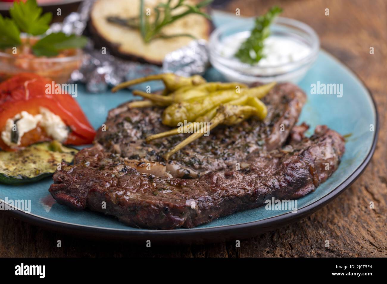 Grilled steak with potatoes on wood Stock Photo