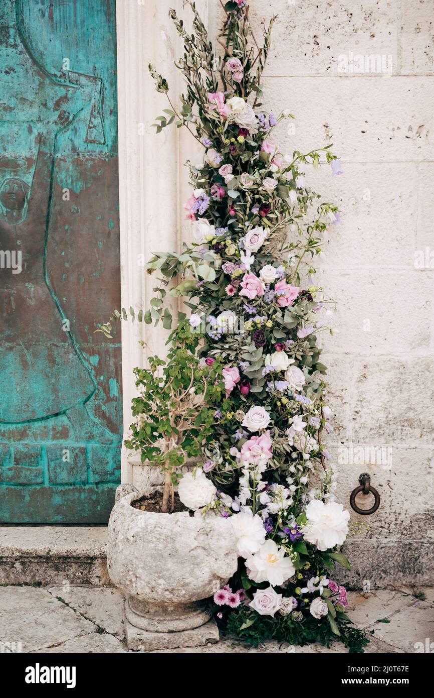 Floral wedding decor near stone wall and flowerpot Stock Photo