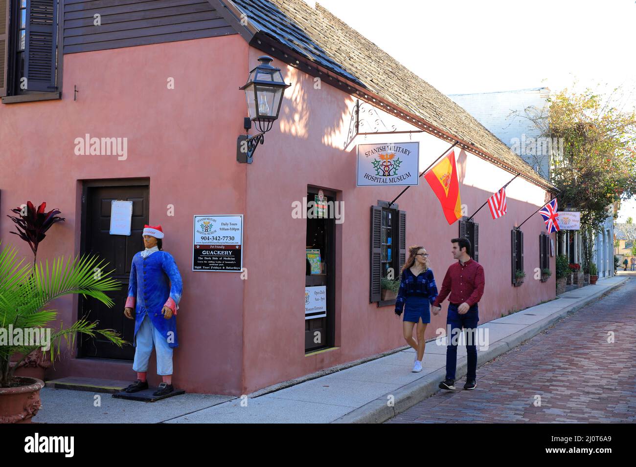 Visitors walking pass by the Spanish Military Hospital Museum at Aviles Street the nation's oldest street in Old Town of St.Augustine.Florida.USA Stock Photo
