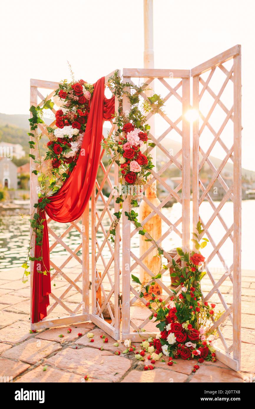 Wooden folding wedding screen stands on the cobbled pier Stock Photo