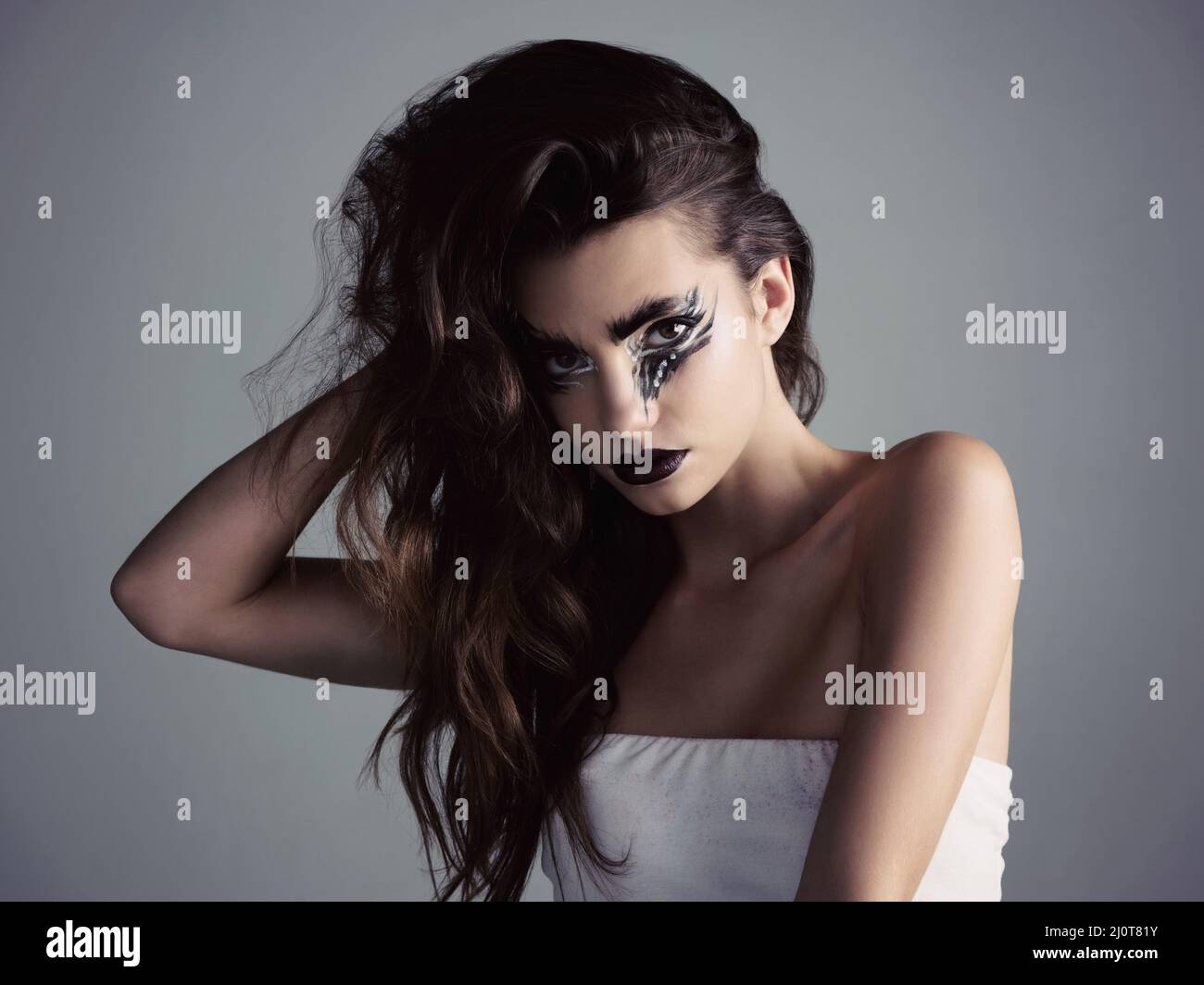 Makeup is an art and we can be artists. Studio shot of an attractive young woman wearing bold makeup. Stock Photo