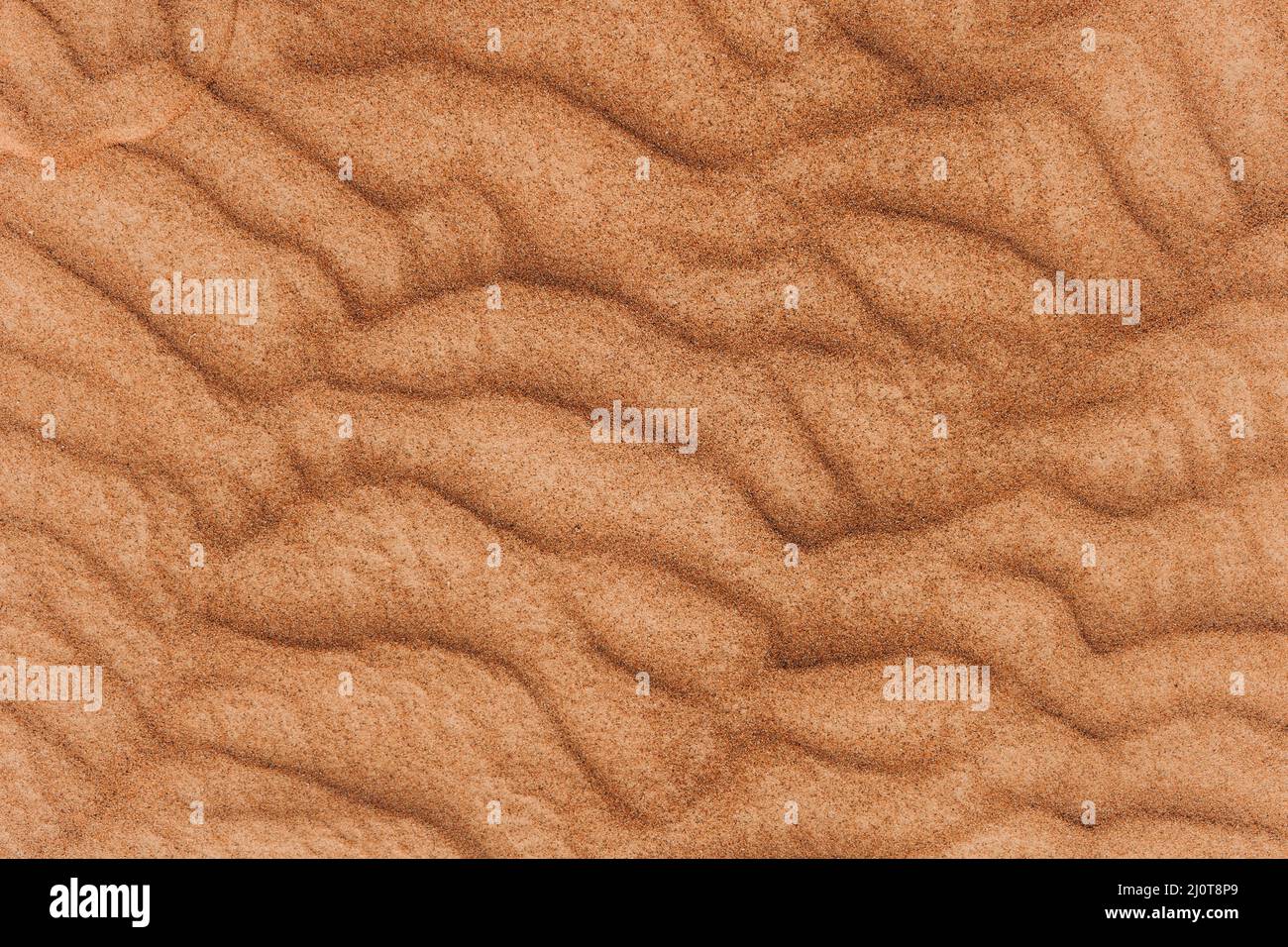 Texture of the sand in the desert. Wavy sand background. Top view. Stock Photo