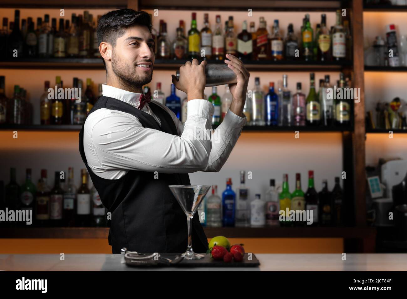Bartender shaking cocktail shaker in cocktail bar Stock Photo Alamy