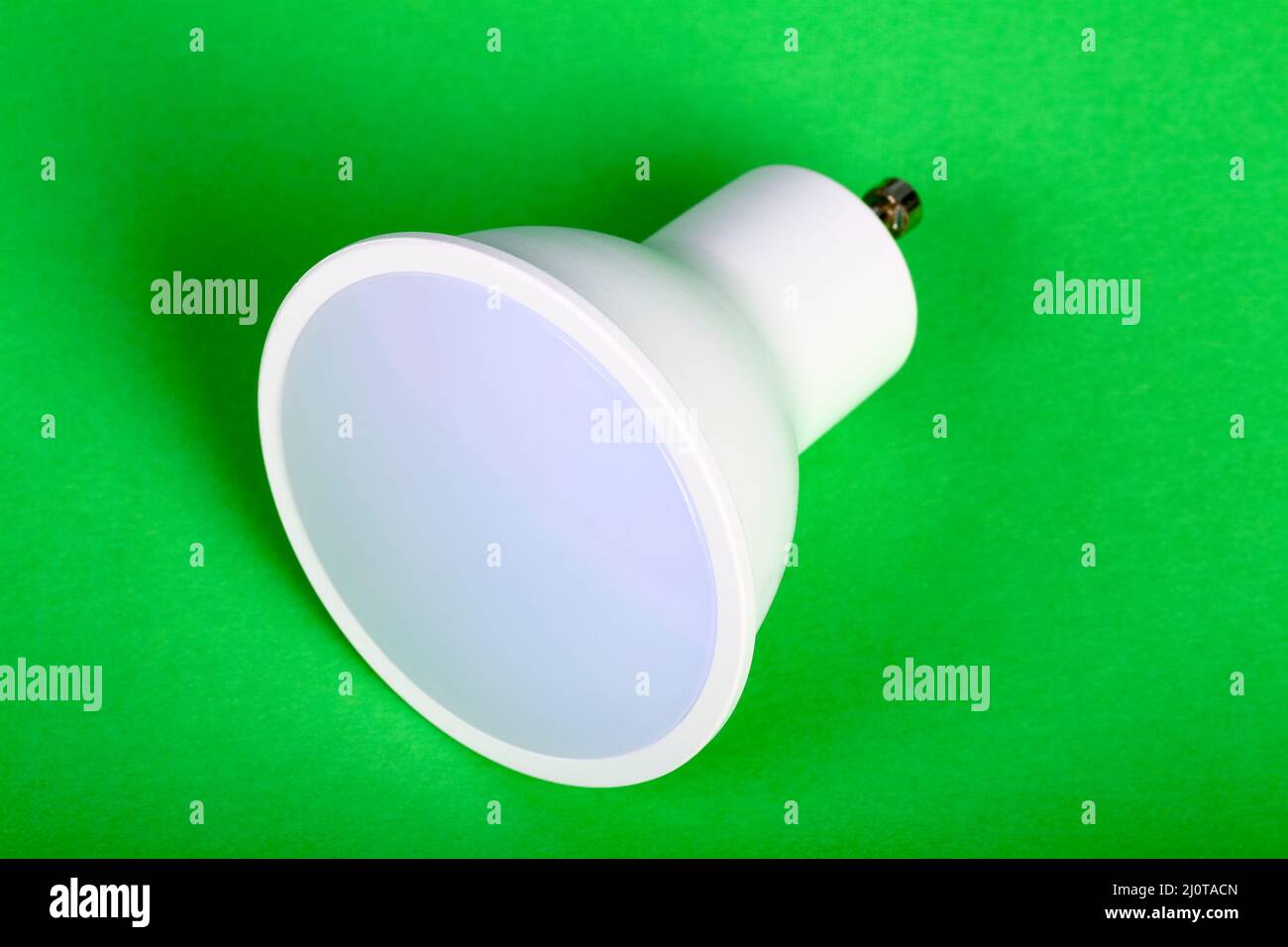 One energy saving GU10 led bulb isolated on a green background Stock Photo