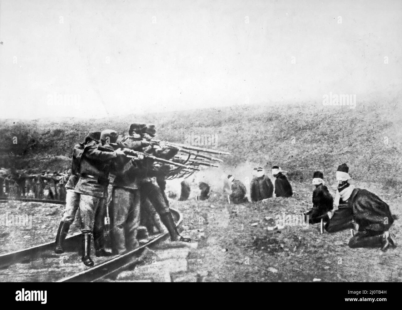 Serbian civilian prisoners arranged in a semi-circle, executed by an Austrian firing squad in World War I. Stock Photo