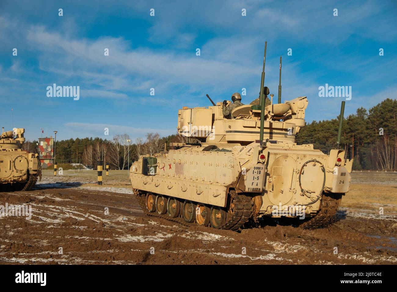 Soldiers assigned to Charlie Company “Fighting Aces,” of 2nd Battalion, 34th Armored Regiment, 1st Armored Brigade Combat Team, 1st Infantry Division, move their Bradley Fighting Vehicle downrange to participate in table VI as part of their qualification process at Konotop Range, Drawsko Pomorskie Training Area, Poland, January 22, 2022. The crews are evaluated on their performance during Table VI, which consists of eight tasks designed to train the tank crew to engage stationary and moving targets. (U.S. Army photo by Sgt. Tara Fajardo Arteaga) Stock Photo