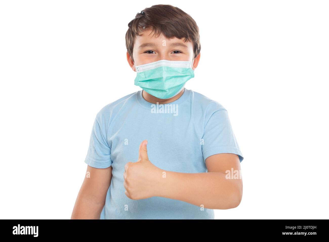Child boy with mask against coronavirus corona virus showing thumbs up isolated crop exempted Stock Photo