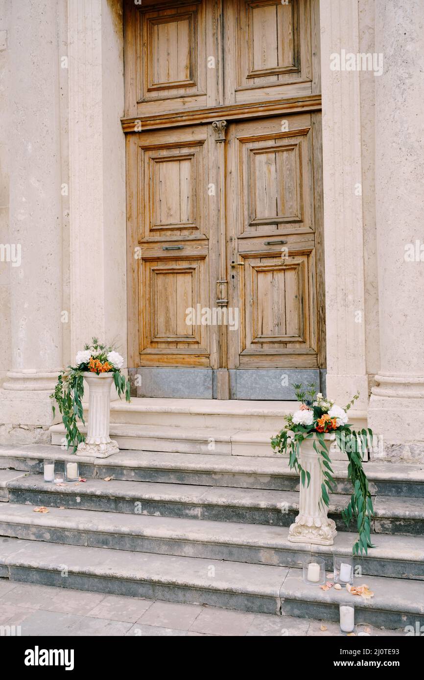 Bouquets of flowers lie on small stone columns on the steps Stock Photo ...