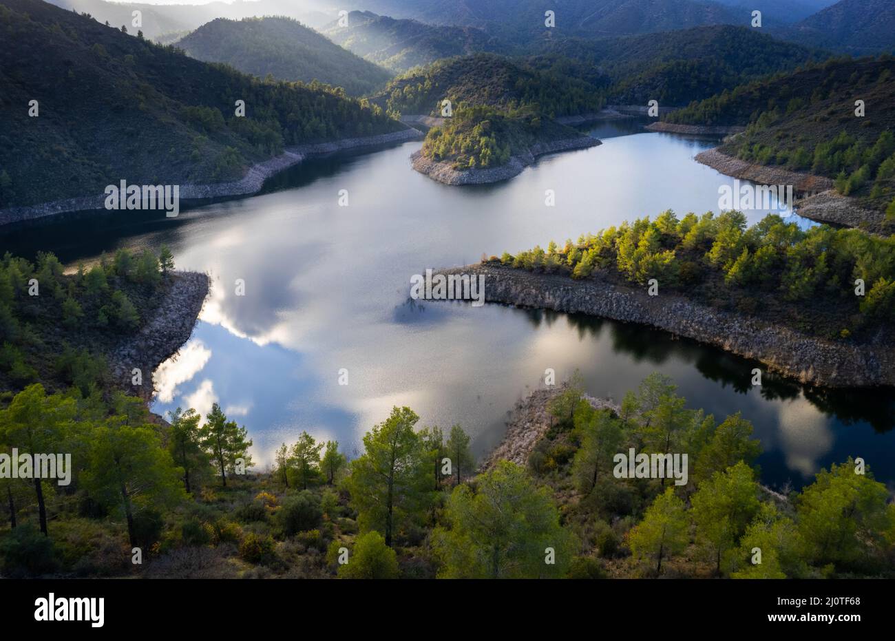 Aerial drone view of a dam full of water in the forest. Lefkara reservoir Larnaca Cyprus Stock Photo