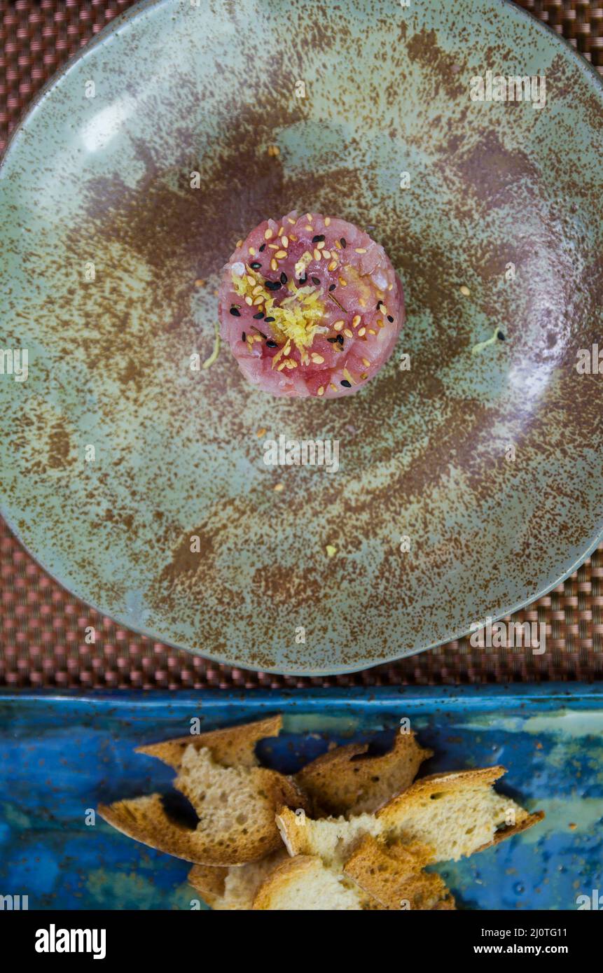 Delicious tuna tartar on a beautifully decorated plate. Stock Photo