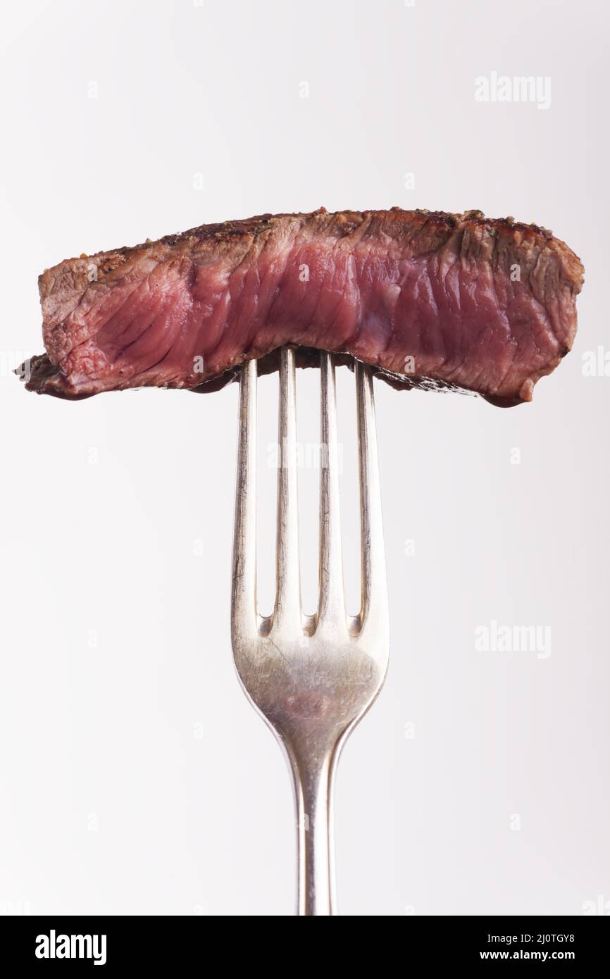 Piece of grilled steak on the fork Stock Photo