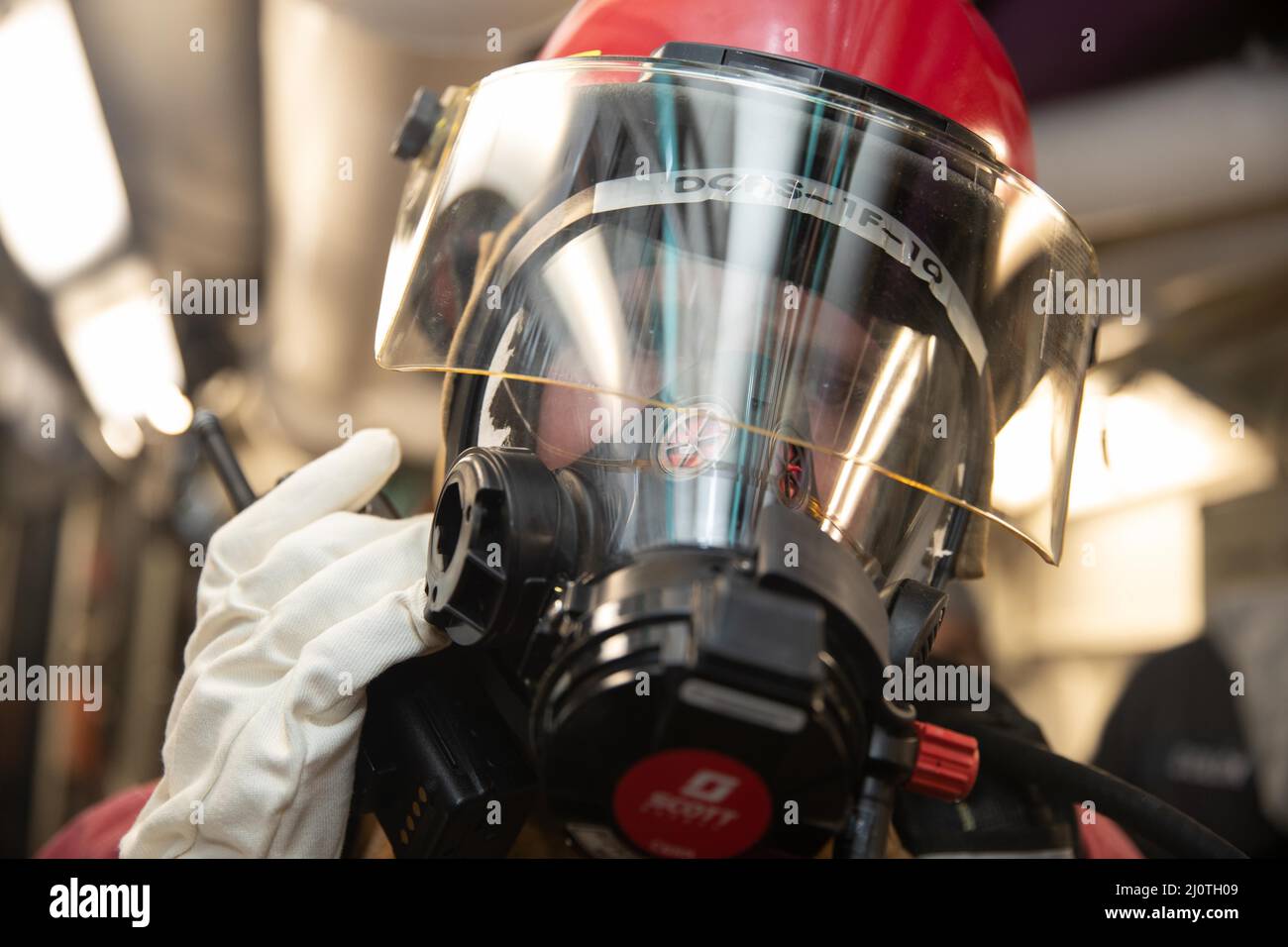 220511-N-PA815-1077  NEWPORT NEWS, Va. (Jan. 25, 2021) - Damage Controlman 3rd Class Trevor P. Conyers, assigned to the engineering department aboard the Nimitz-class aircraft carrier USS George Washington (CVN 73), communicates with repair locker 1B during an integrated class bravo fire drill aboard the ship. George Washington is currently undergoing refueling complex overhaul (RCOH) at Newport News Shipbuilding. RCOH is a multi-year project performed only once during a carrier’s 50-year service life that includes refueling the ship’s two nuclear reactors, as well as significant repairs, upgr Stock Photo