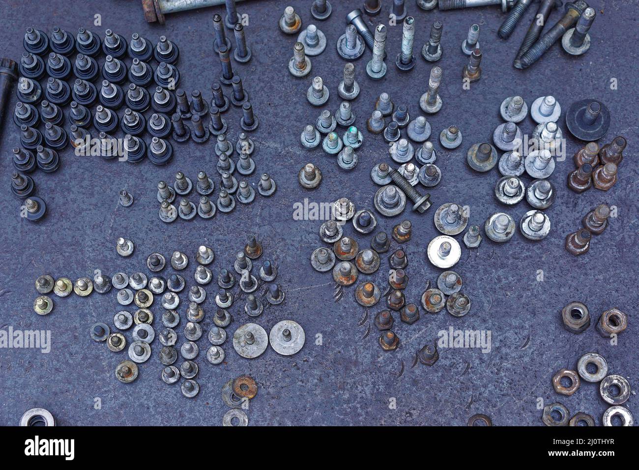 Bolts screws and nuts in upright position at workbench service garage