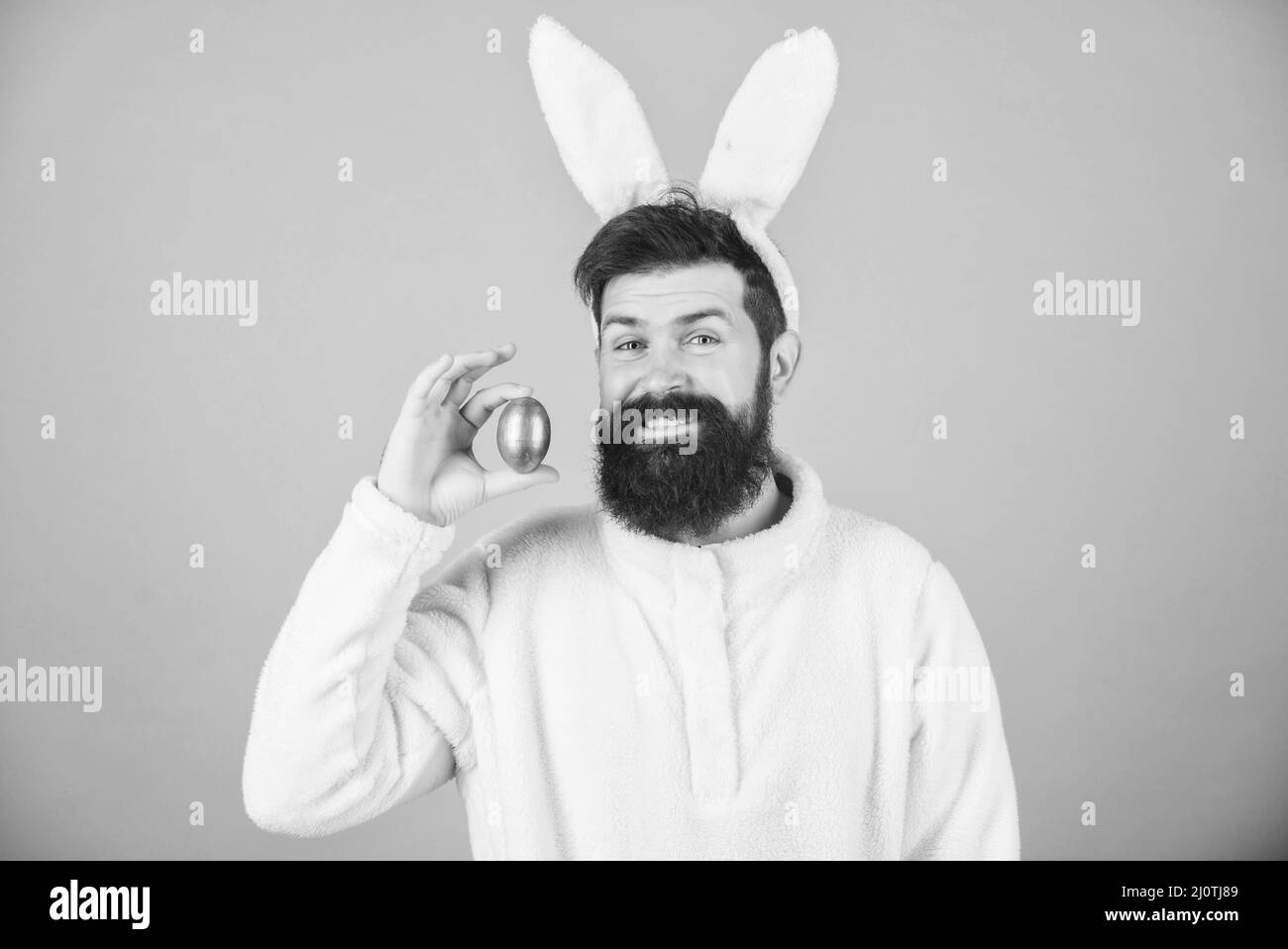 Funny bunny with beard and mustache. Join celebration. Having fun. Grinning bearded man wear silly bunny ears. Easter symbol concept. Hipster cute Stock Photo