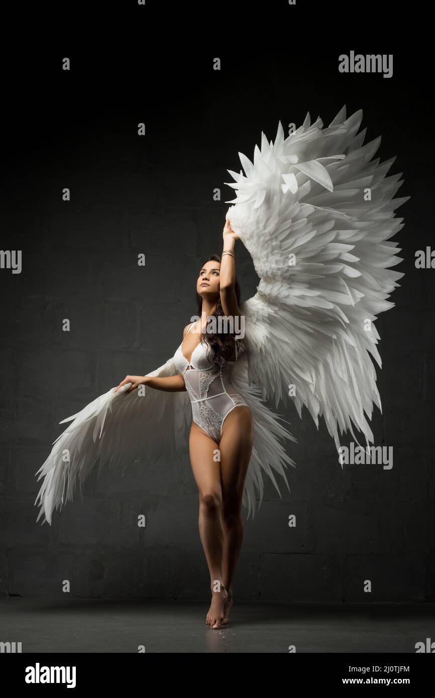Gorgeous woman in underwear and angel wings in studio Stock Photo