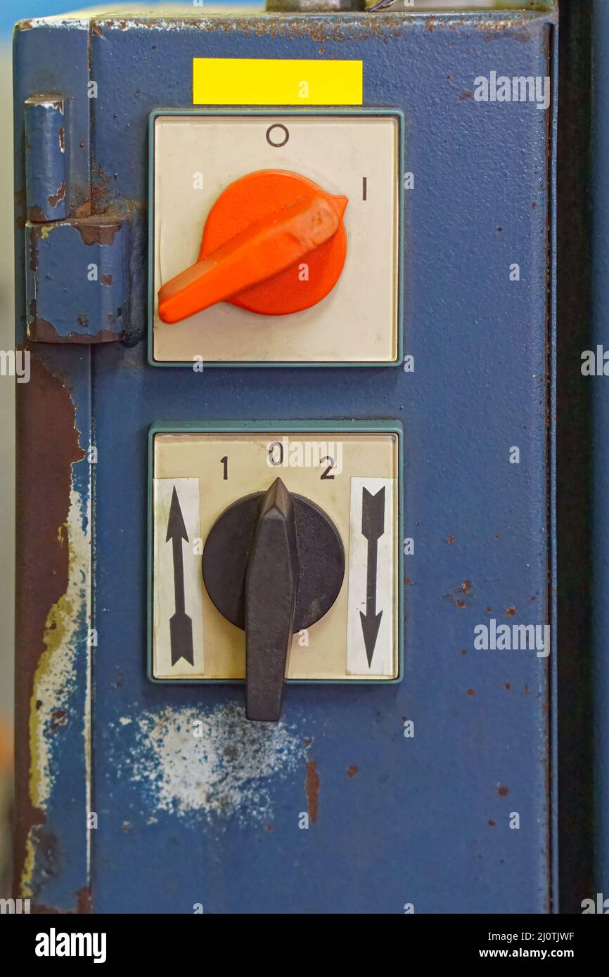 Machine electric power switch with direction control arrows Stock Photo