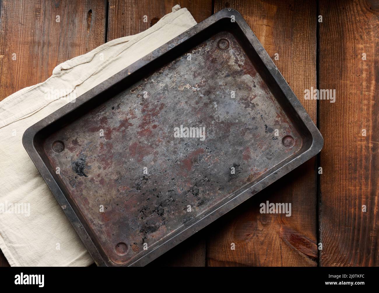 Empty rectangular iron rusty baking sheet on a wooden brown table, top view Stock Photo