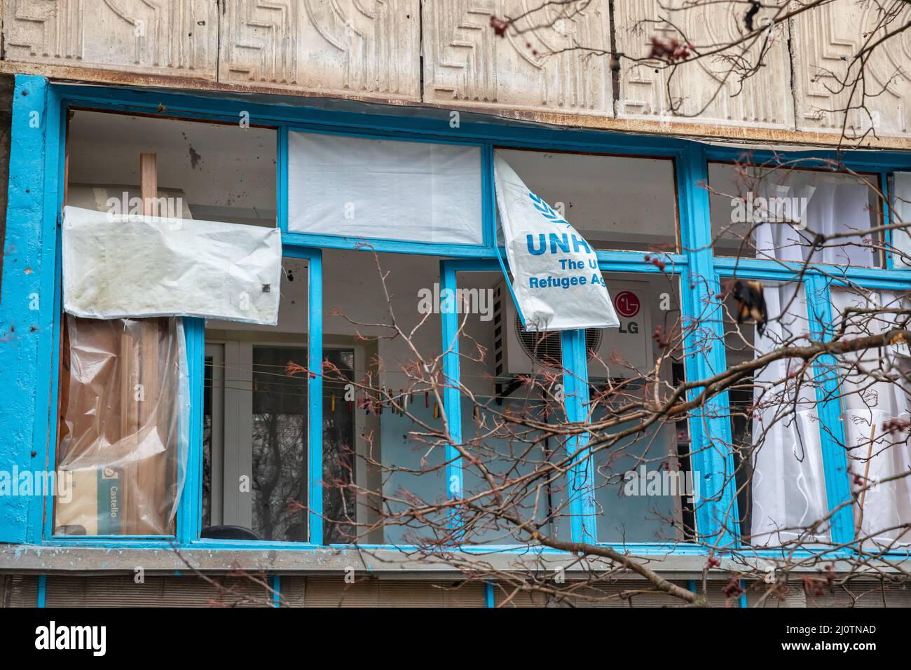 THE UNHCR flag in one window after the explosion of the Grad rocket. Stock Photo