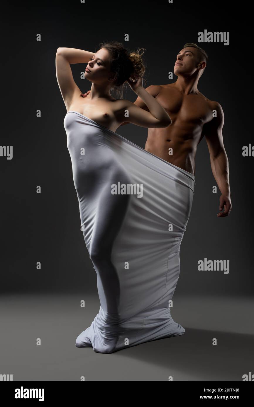 Naked seductive couple wrapped in white cloth Stock Photo