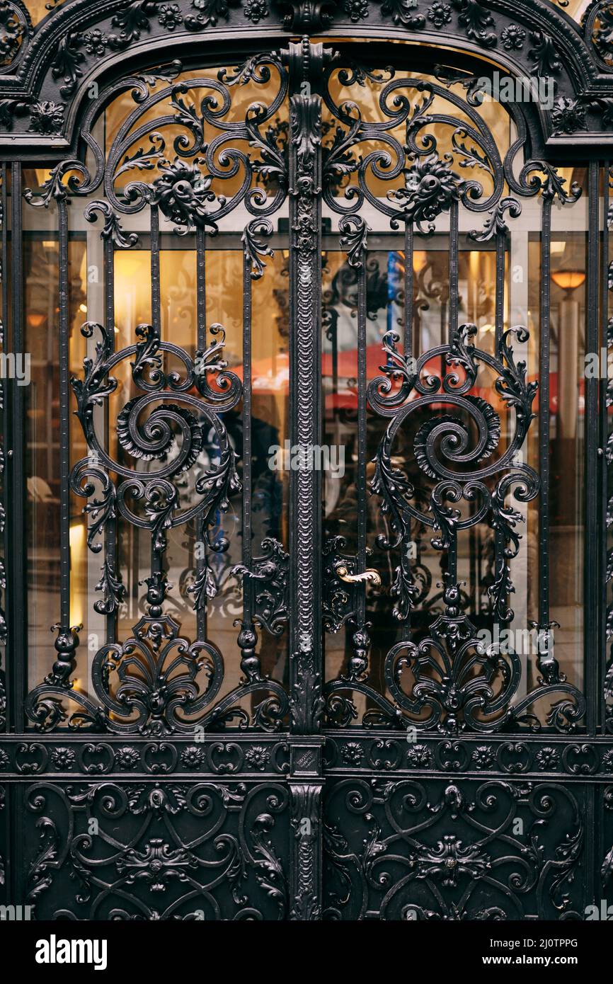 Black metal forged fence with floral ornaments Stock Photo