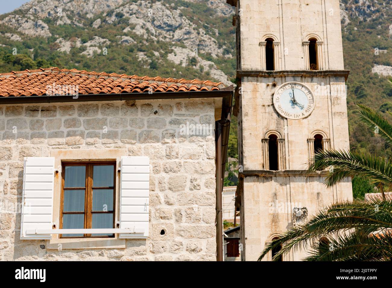 Church of St. Nicholas and a bell tower with a clock. Perast, Montenegro Stock Photo