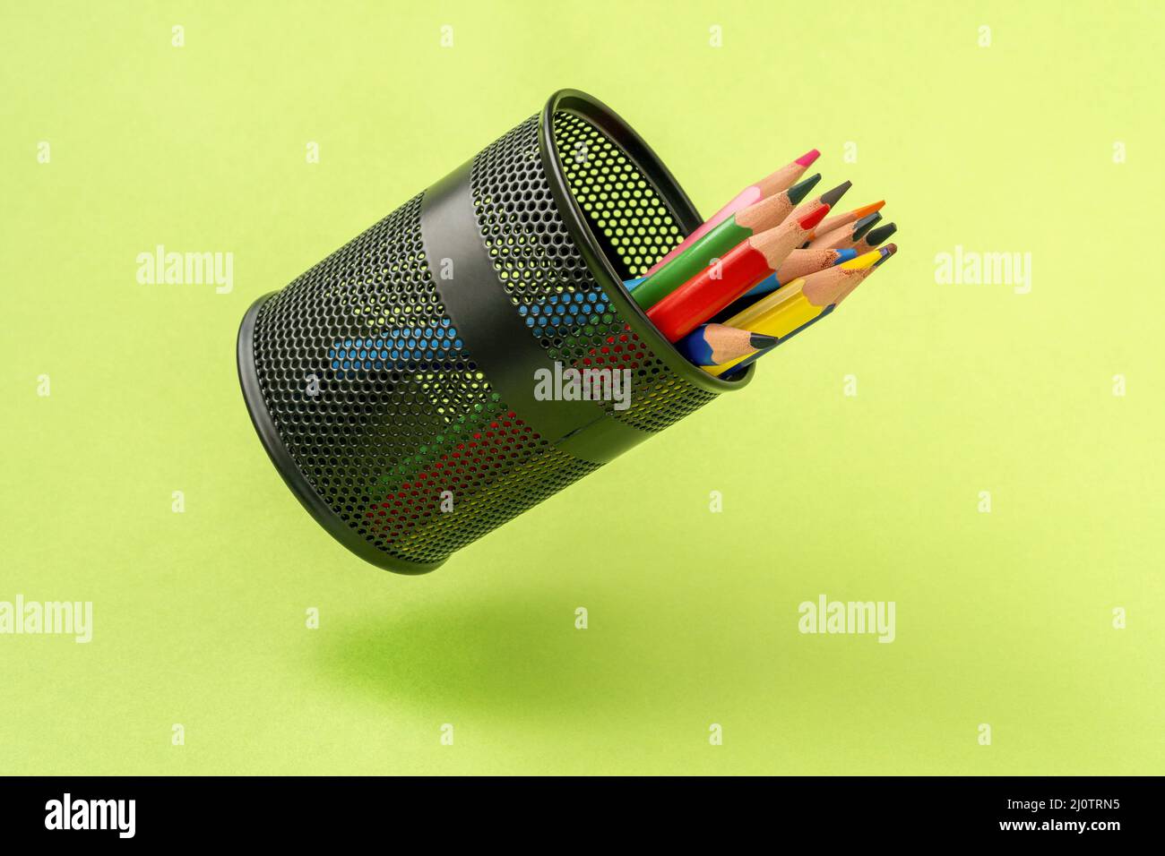 Colored pencils in a black mesh pen pot Stock Photo