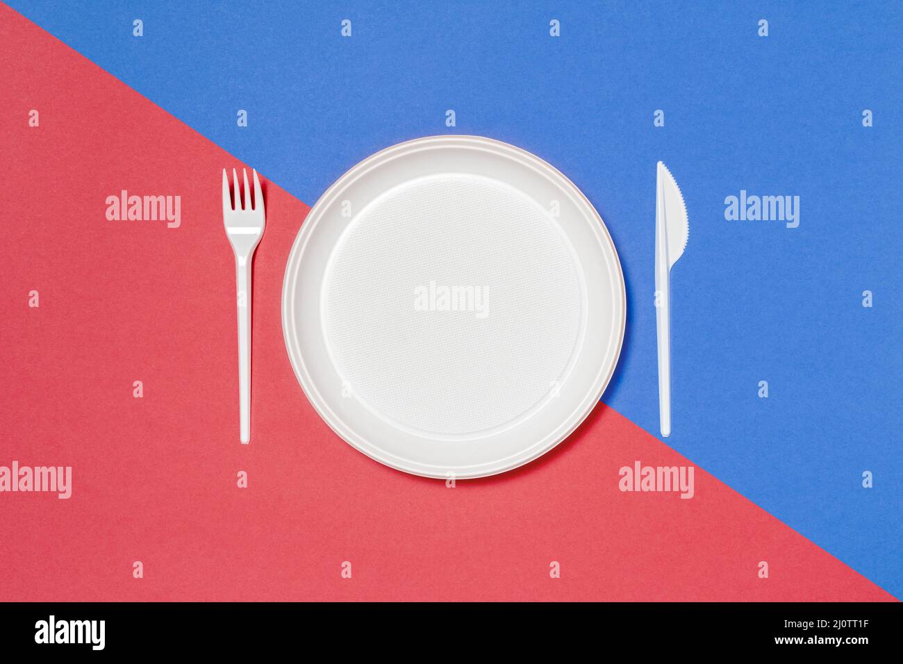 Set of white disposable tableware on colored background Stock Photo