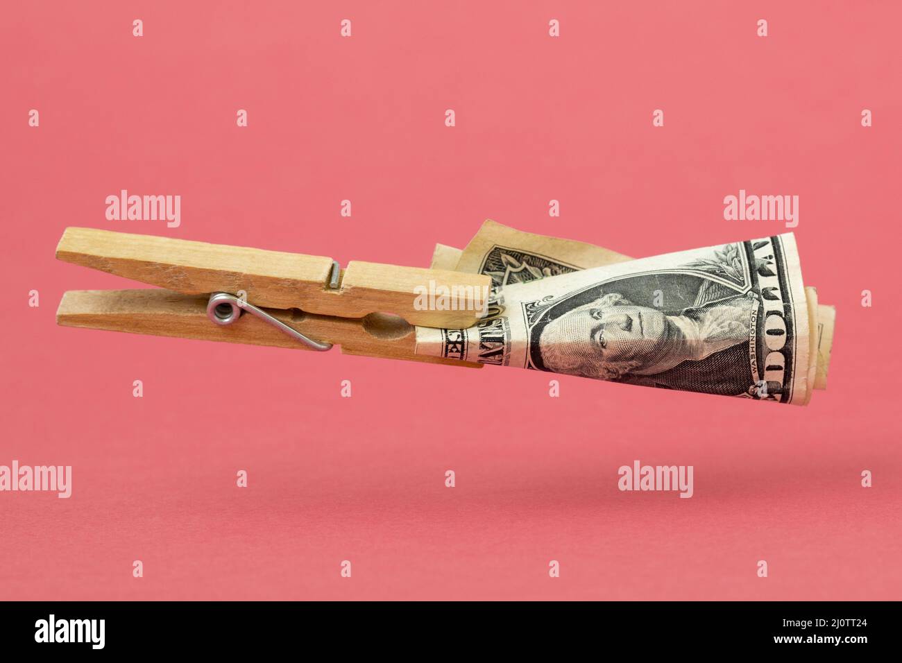Wooden clothes pin with one dollar Stock Photo Alamy