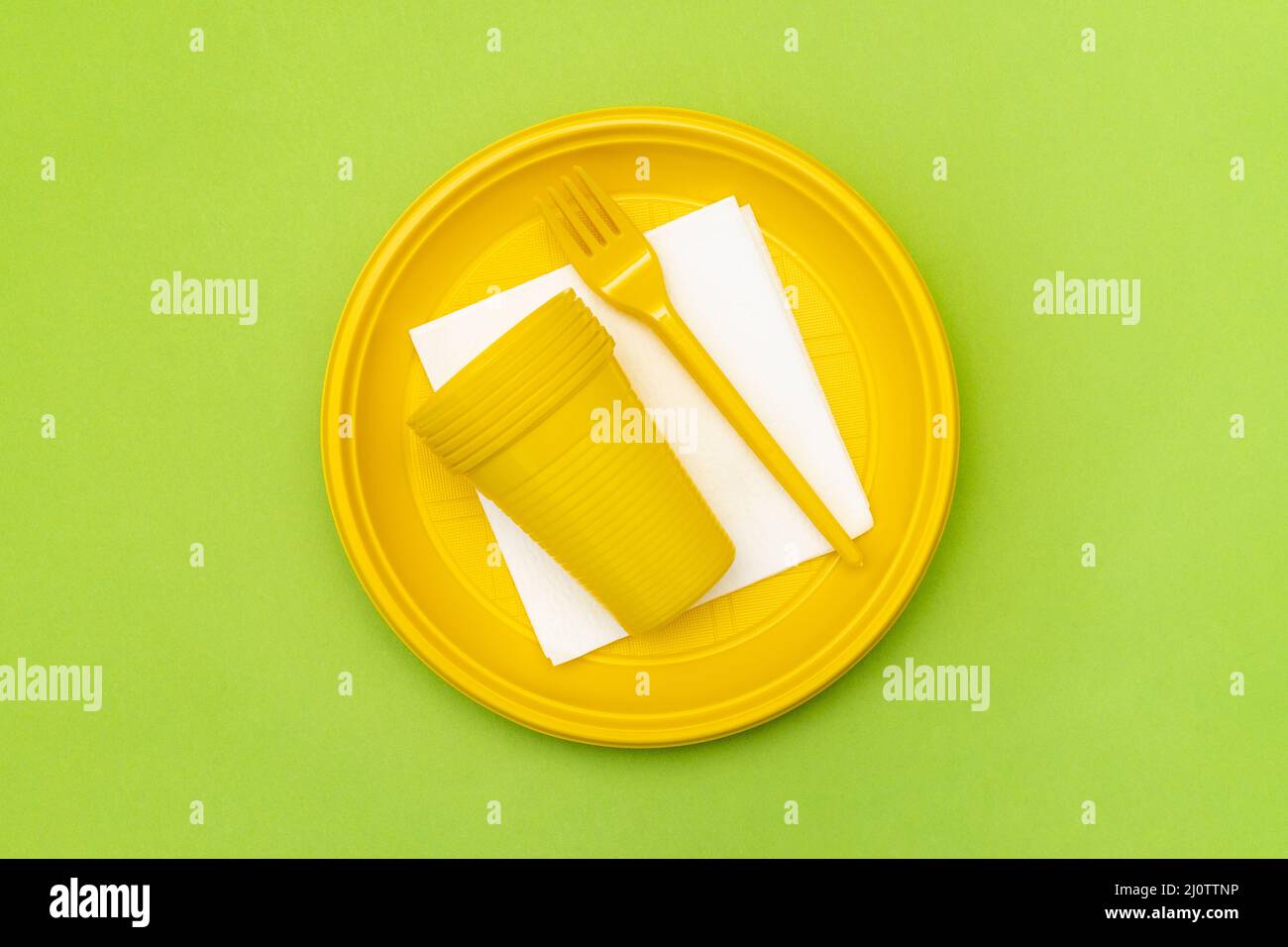 Disposable yellow plastic plates, forks and cups Stock Photo Alamy