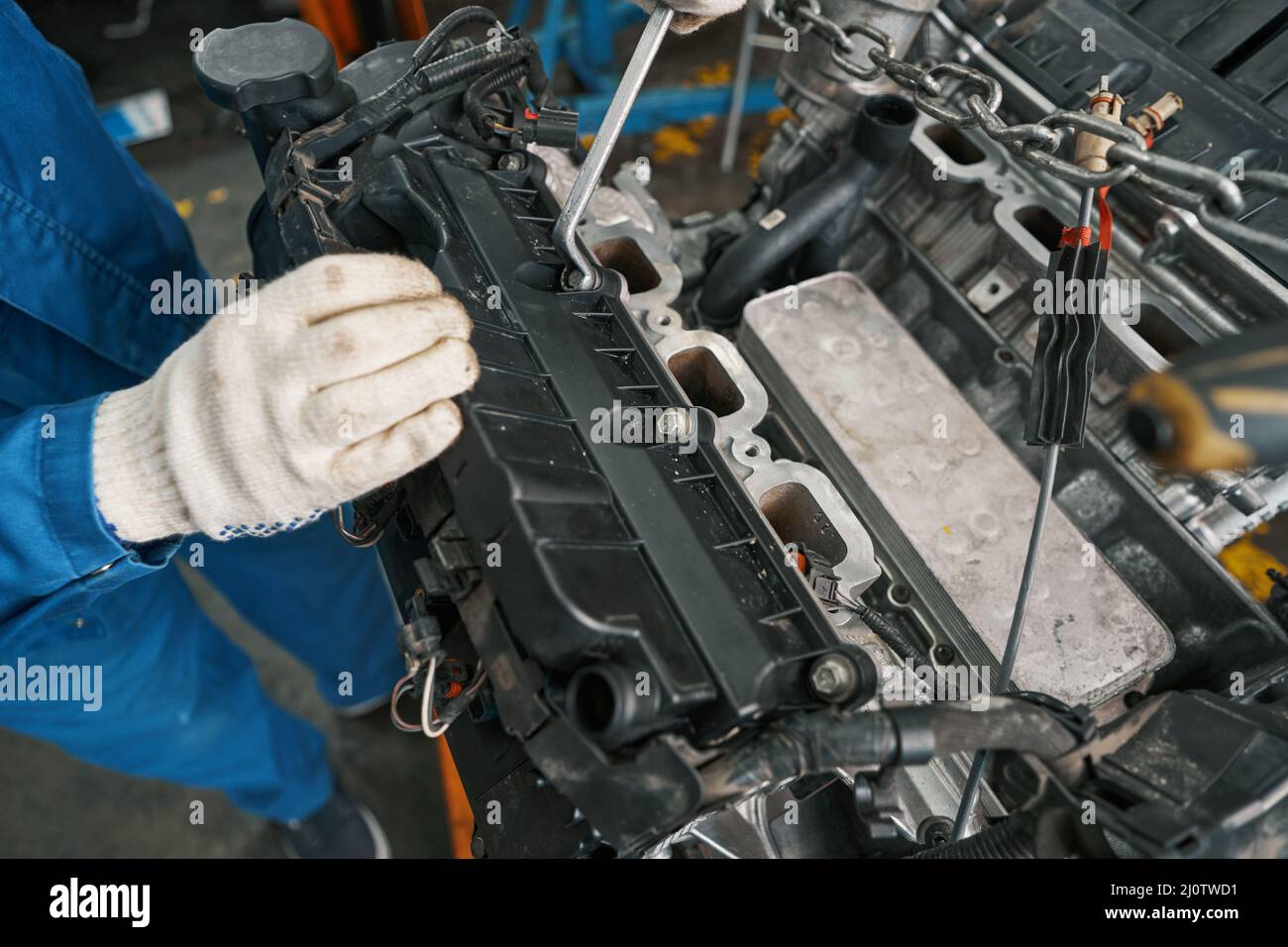 Close-up photo of male inspecting auto detail during repair Stock Photo ...