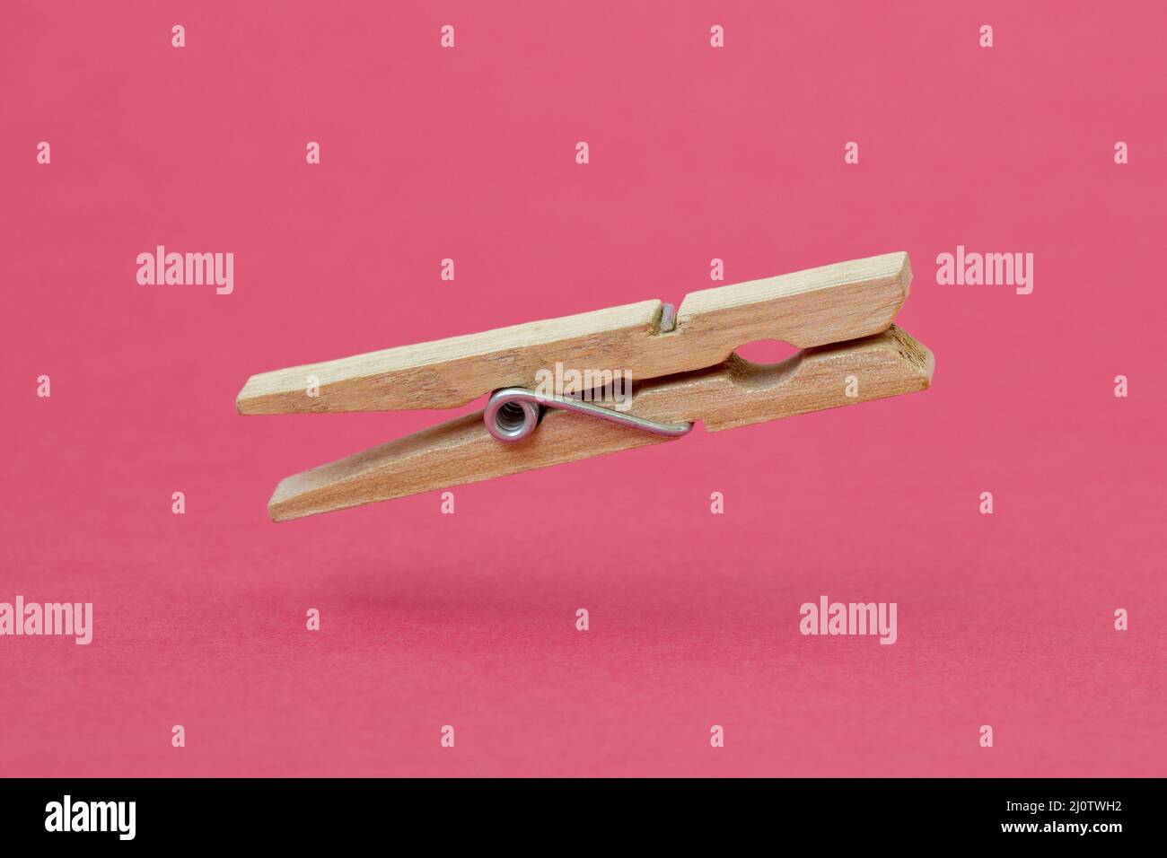 Wooden cloth peg over pink background Stock Photo Alamy