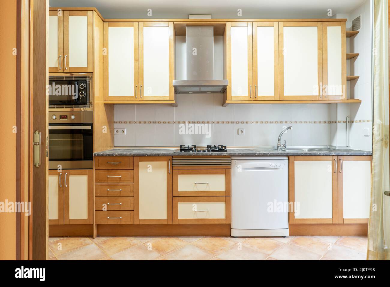 kitchen with wooden furniture and matching drawers with gray stone