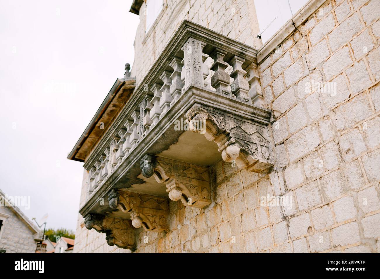 Carved stone balcony on the facade of the building with carved balusters Stock Photo