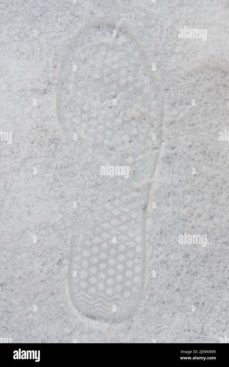 Shoe print and footprints in the snow - sole profile Stock Photo