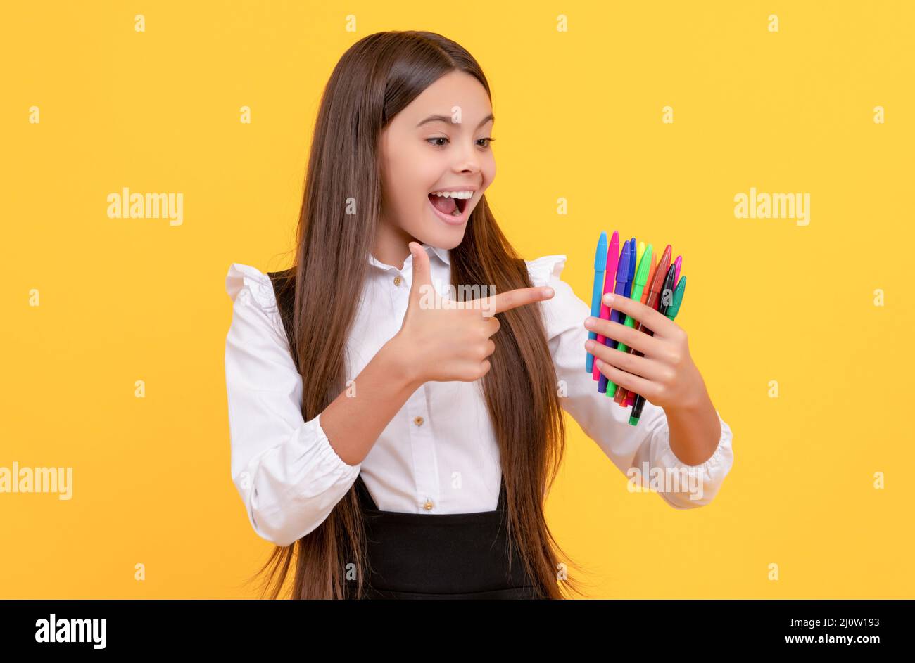 Get one in every color. Happy kid point finger gun at felt pens. The best felt pens you ever had. Stock Photo