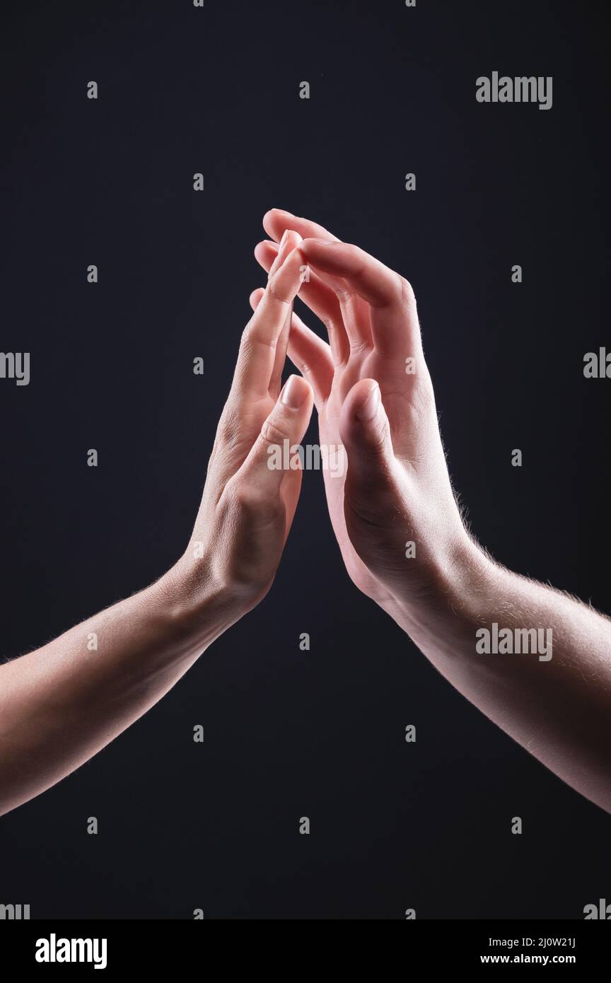 A close-up of two hands male and female gently touch each other. The concept tremulous rejection between the sexes Stock Photo