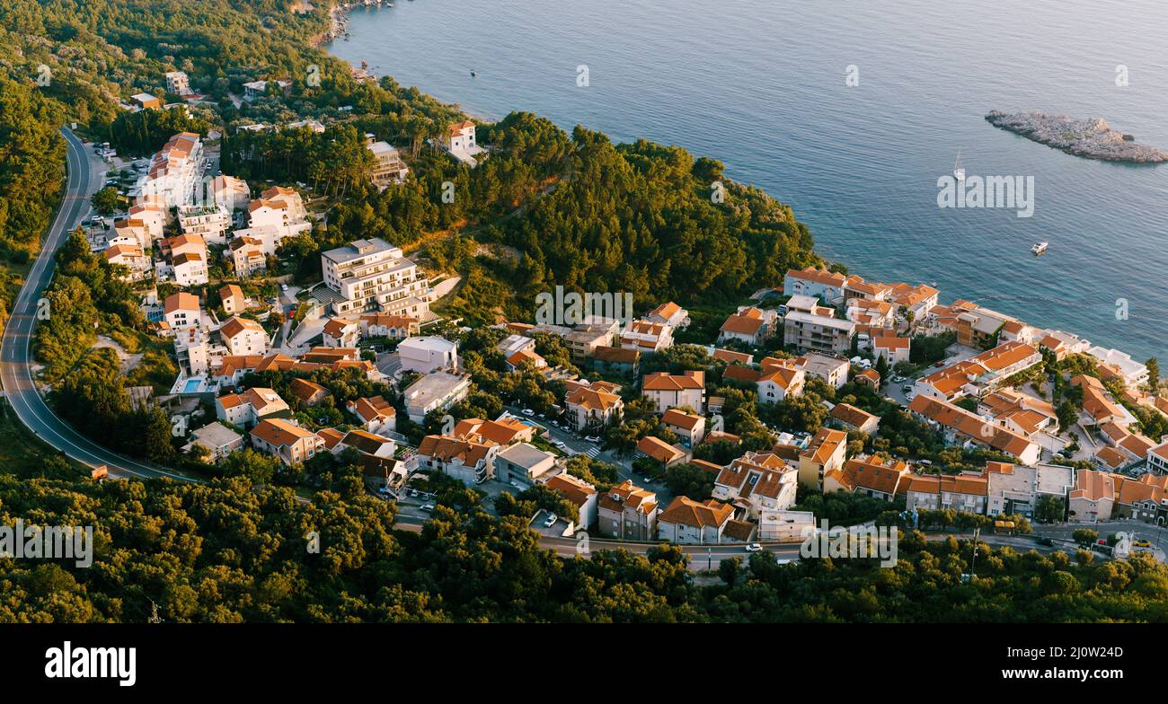 Aerial view of the houses of the seaside town at the foot of the mountains Stock Photo