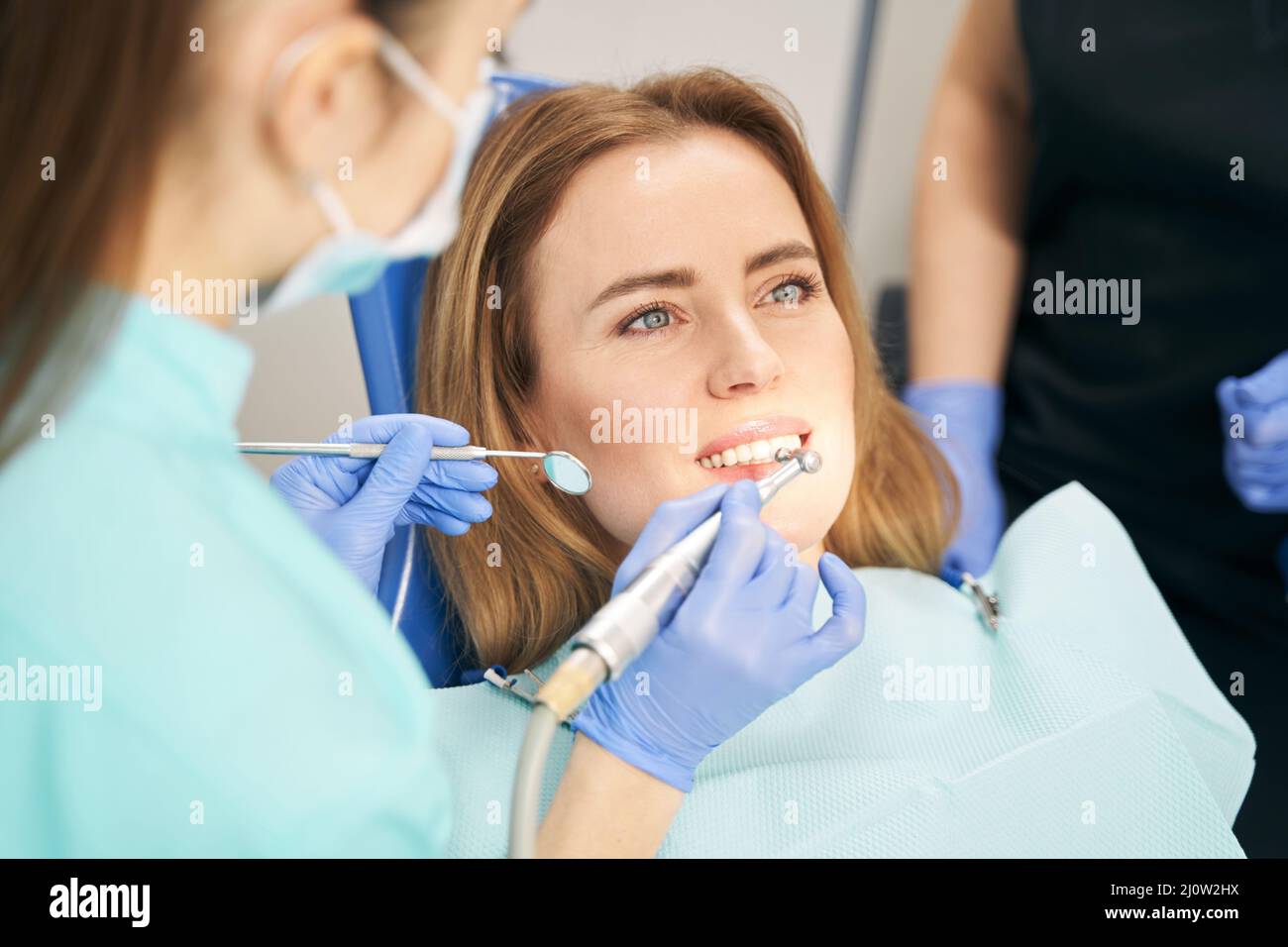 Dentist performing teeth treatment with dental device Stock Photo Alamy