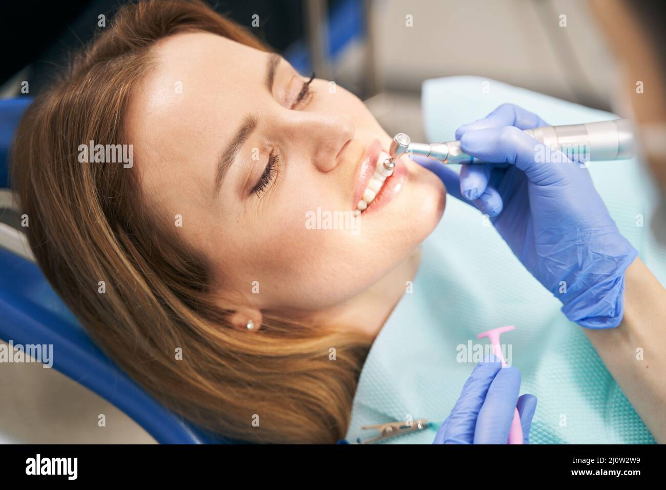 Dentist performing teeth treatment with tooth polisher device Stock Photo Alamy