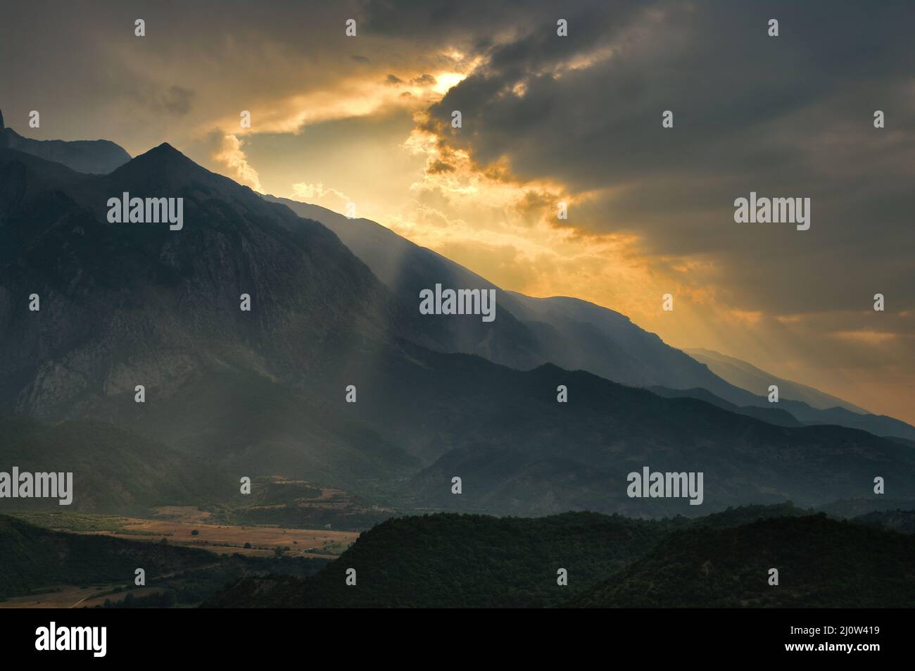 mountain landscape and dramatic storm with sunbeam through clouds in ...