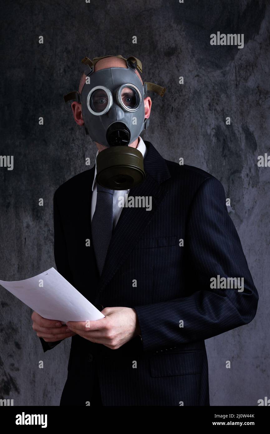 Midsection of man wearing gas mask and holding papers Stock Photo