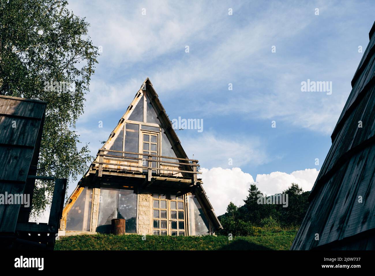 Triangular stone house with a terrace against a blue sky. Montenegro ...