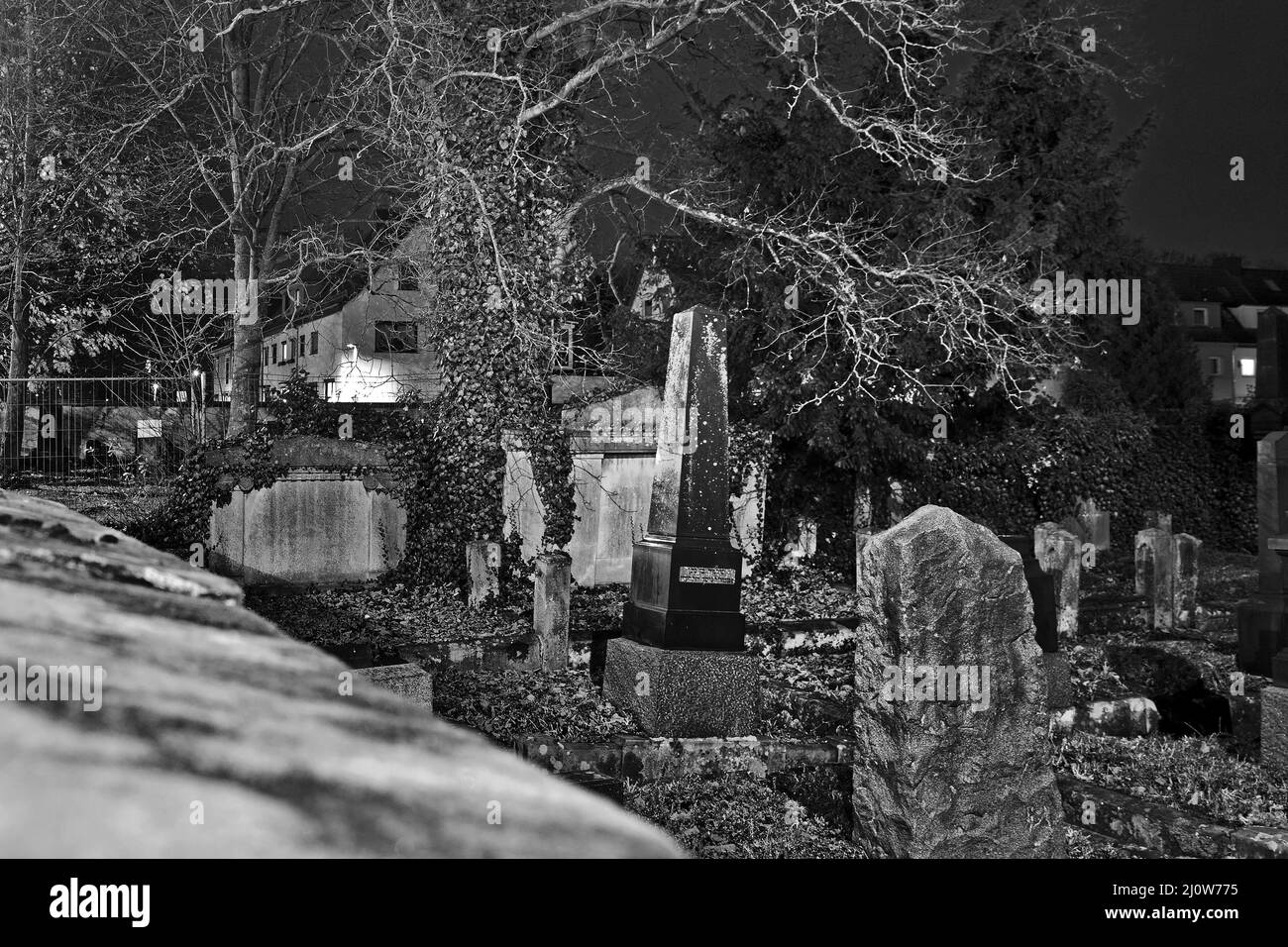 Jewish cemetery at night, in the background Residential buildings, Goettingen, Germany, Europe Stock Photo