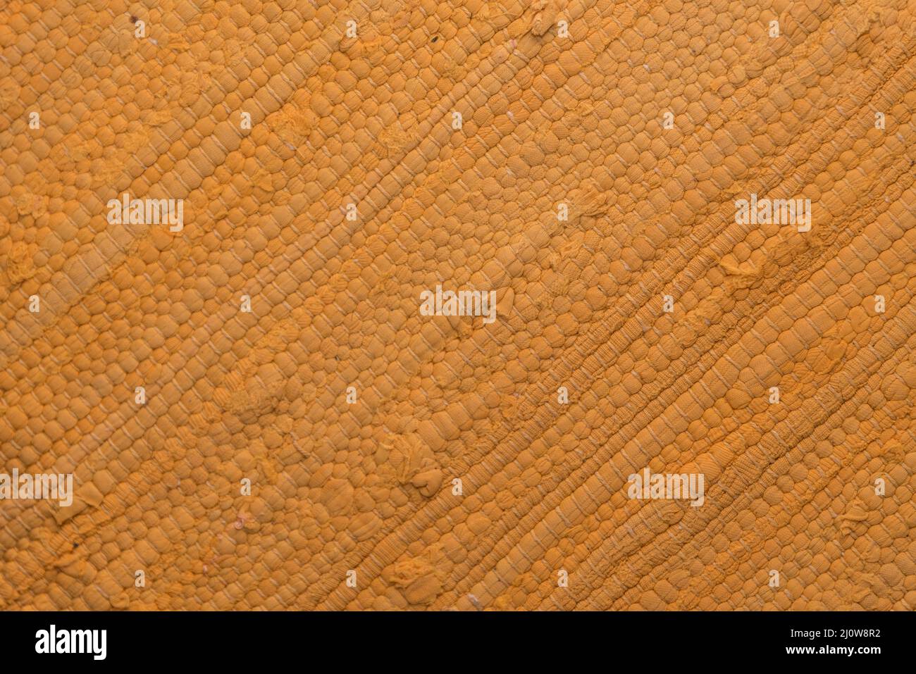 Structure and pattern of an orange carpet - stained carpet and floor carpet Stock Photo