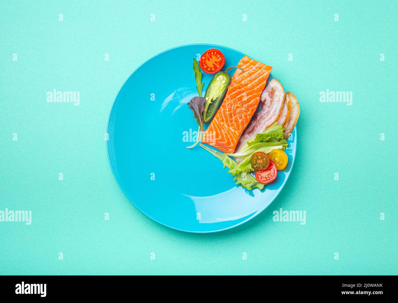 Intermittent fasting low carb hight fats diet concept flat lay, healthy food on blue plate Stock Photo