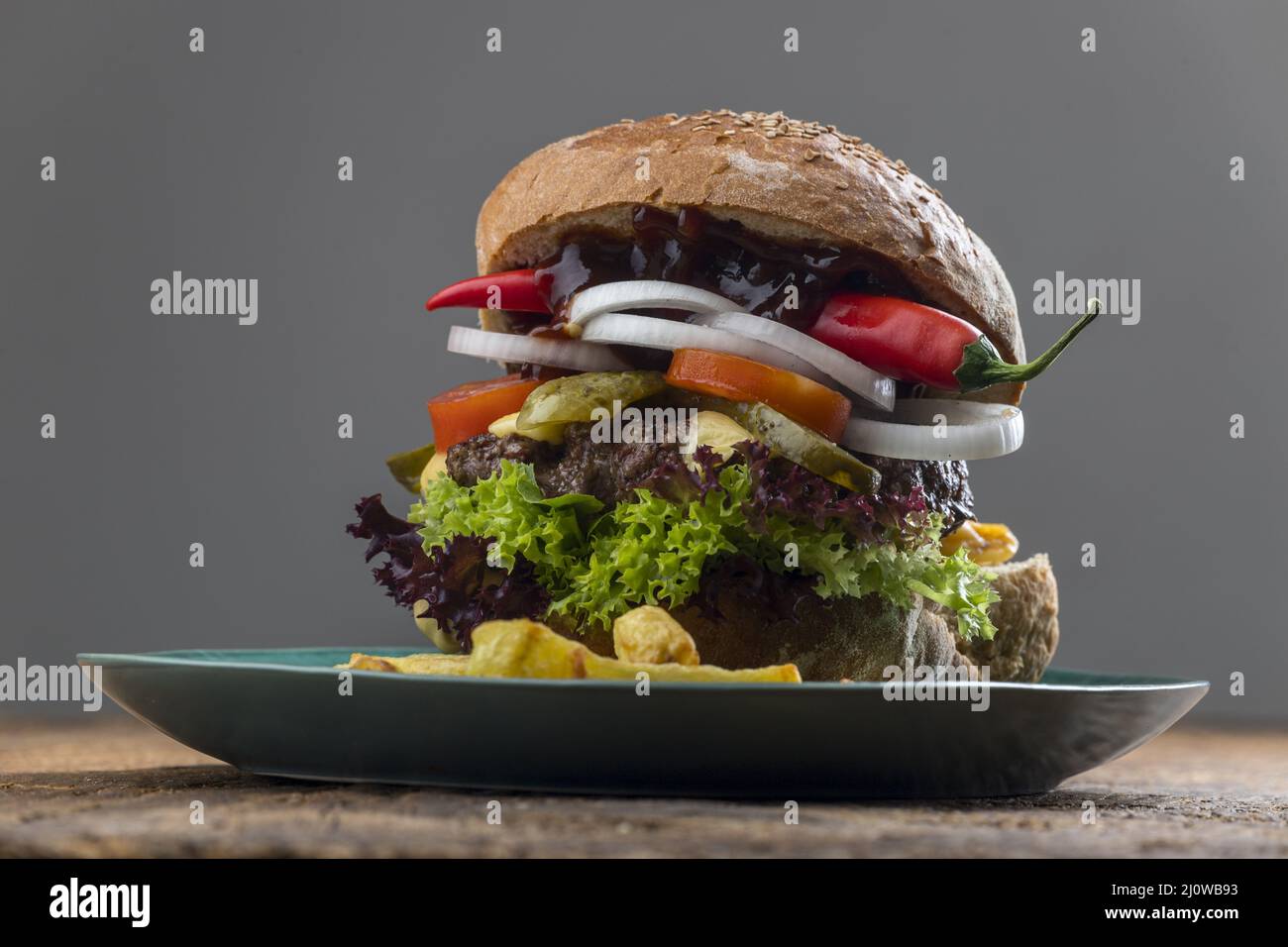 Cheeseburger on blue plate with chili Stock Photo
