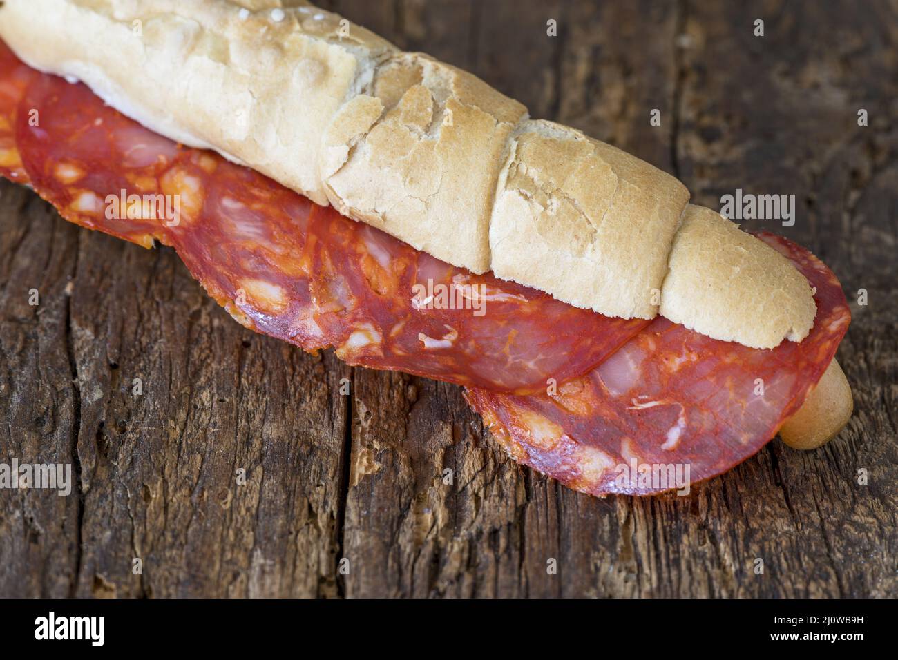 Spanish chorizo slices in bread Stock Photo