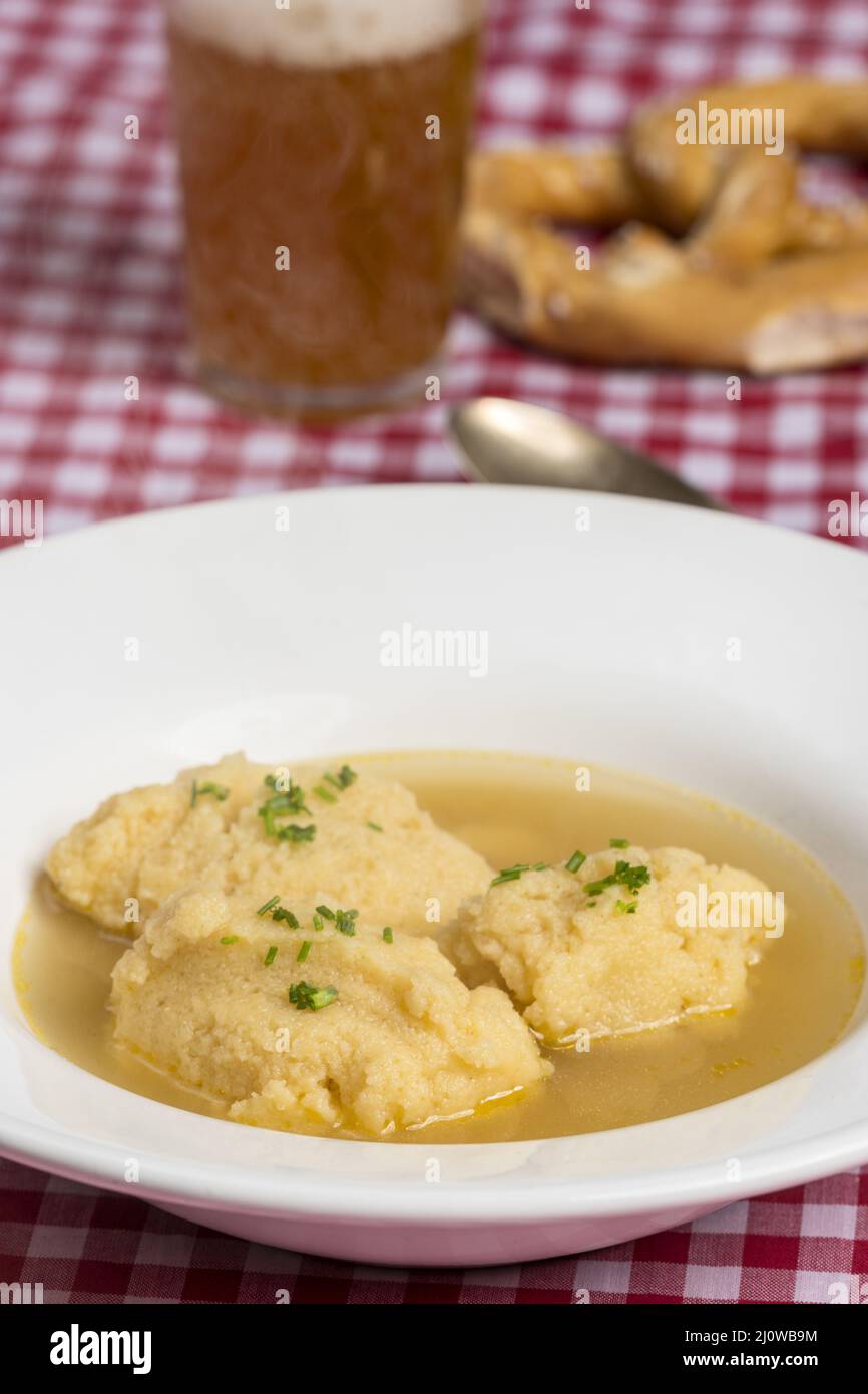 Bavarian semolina gnocchi soup on tablecloth Stock Photo