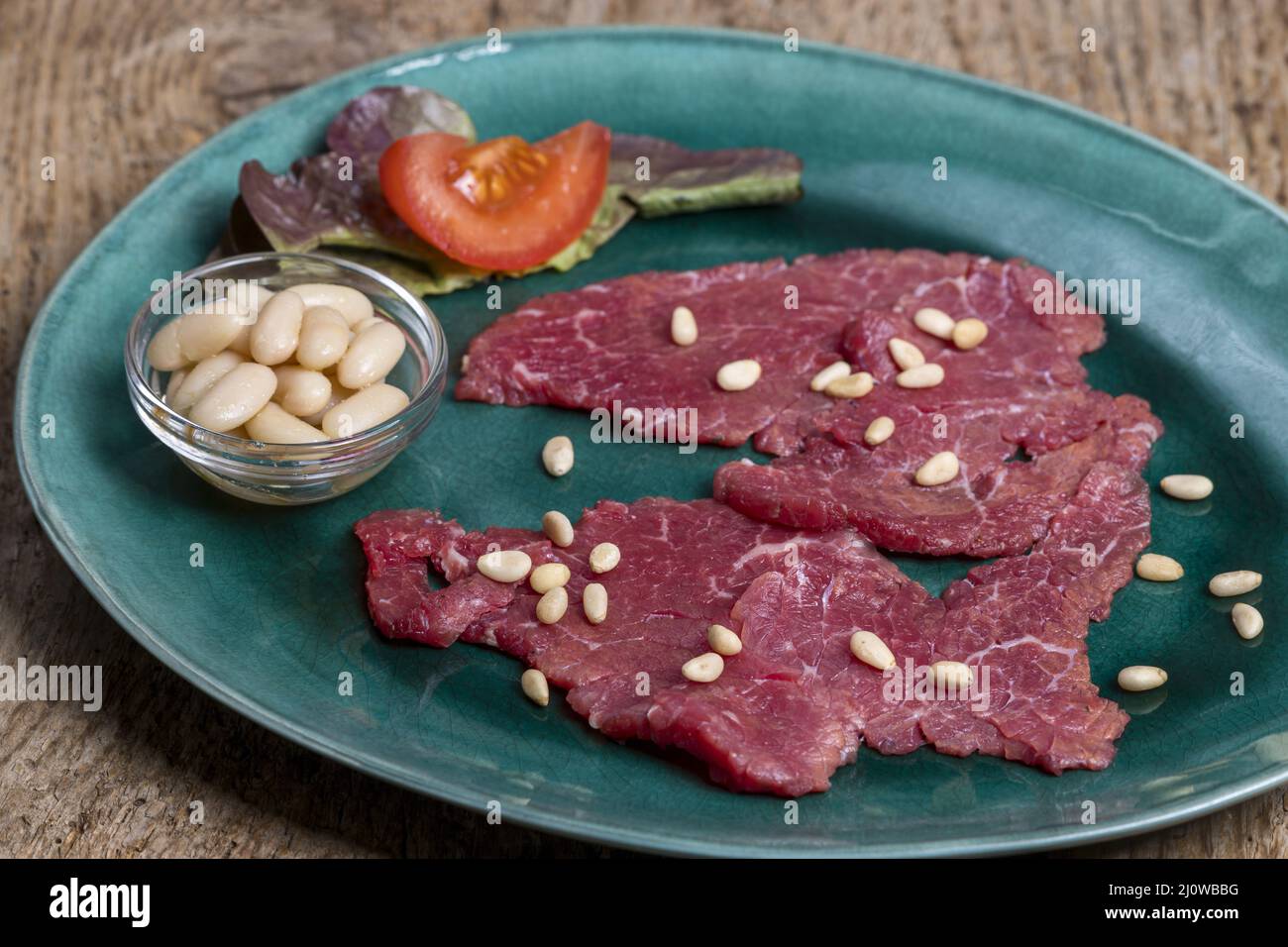 Italian carne salada on a green plate Stock Photo