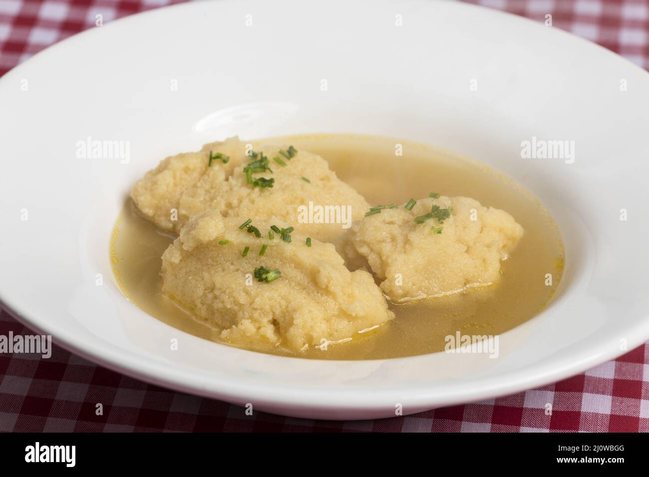 Bavarian semolina gnocchi soup on tablecloth Stock Photo